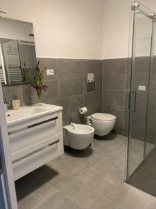 a bathroom with a sink and a toilet and a shower at Santa Caterina Apartament in Poggibonsi