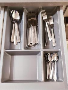 a drawer with utensils in a kitchen sink at Appartment in Espoo in Helsinki