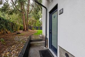 a door to a house with a yard at Modern King-Size Guest Suite with AC in Burnaby