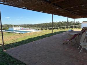 a patio with a view of a swimming pool at Herdade dos Calvinos, Monte 2 - Alandroal in Parreiras