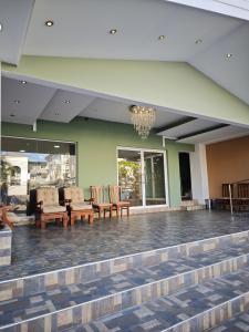 a lobby with chairs and a chandelier at Hotel Rubinos in San Salvador