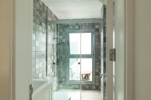 a bathroom with a shower and a window at Hotel The Cathedral Vegueta in Las Palmas de Gran Canaria +48 photos