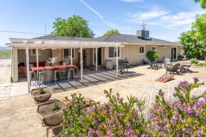 a house with a patio with a table and chairs at Boots and Barrels Ranch in Paso Robles