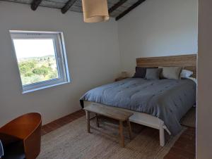 a white bedroom with a bed and a window at Herdade dos Calvinos, Monte 2 - Alandroal in Parreiras +48 photos