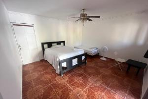 a bedroom with a bed and a ceiling fan at Value guests in Magaeline