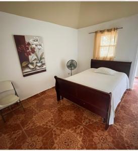a bedroom with a large bed and a chair at Value guests in Magaeline