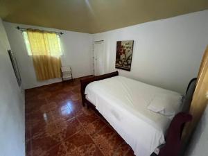 a bedroom with a white bed and a window at Value guests in Magaeline