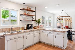 a kitchen with white cabinets and a counter top at Boots and Barrels Ranch in Paso Robles +15 photos