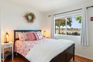 a bedroom with a bed and a window at Boots and Barrels Ranch in Paso Robles