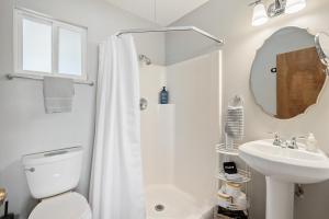 a bathroom with a shower and a toilet and a sink at Boots and Barrels Ranch in Paso Robles
