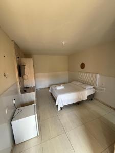 a room with a bed and a sink in it at Hotel pousada Xique Xique in Piranhas +8 photos