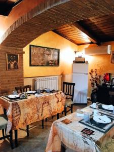 a dining room with two tables and a refrigerator at I Santicelli in Morano Calabro +19 photos