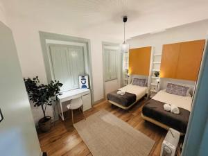 a room with two beds and a desk in it at Lisboa Hostel in Lisbon +28 photos