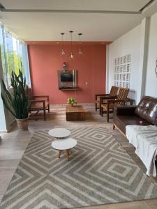 a living room with a couch and a tv at Hotel pousada Xique Xique in Piranhas