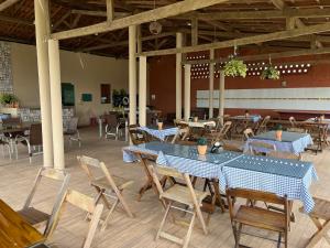 a dining room with blue tables and chairs at Hotel pousada Xique Xique in Piranhas
