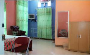 a living room with green curtains and a chair at Hotel SIDAPORE in Lamobuang +9 photos