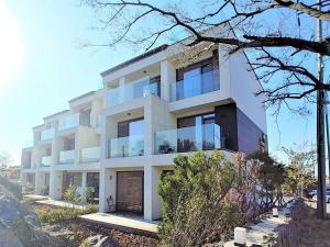 a white building with a lot of windows at Jeju Teracehill Pension in Jeju