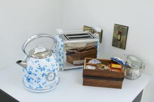a counter with a toaster and a box on it at Lil's Cottage, Grangecon in Grange Con