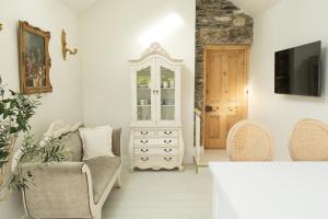 a living room with a couch and a dresser at Lil's Cottage, Grangecon in Grange Con