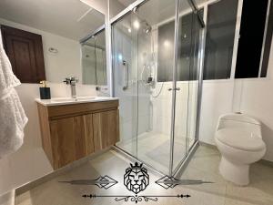 a bathroom with a shower and a toilet and a sink at Casa Hotel Imperion in Bogotá +13 photos