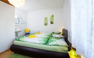 a bedroom with a bed in a room at Haus Babin in Techelsberg am Worthersee