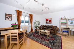 a living room with a table and a couch at Haus Babin in Techelsberg am Worthersee +19 photos