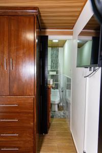 a bathroom with a toilet and a television in a room at Casa Bajareque in Cerro Punta +19 photos