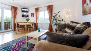 a living room with a couch and a table at Haus Babin in Techelsberg am Worthersee