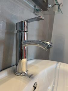 a bathroom sink with a chrome faucet at Ella Repose in Ella +83 photos