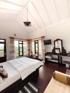 a bedroom with a large bed and a mirror at Ella Repose in Ella