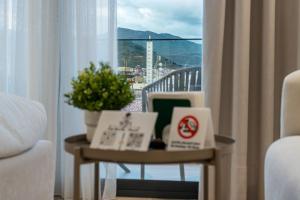 a room with a table with a view of a balcony at Suites Nador in Nador +12 photos