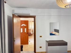 a hallway with a door leading to a bedroom at Kapllani Guest House in Durrës