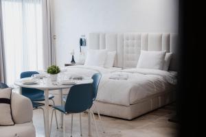 a bedroom with a bed and a table and chairs at Suites Nador in Nador