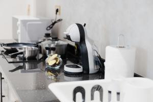 a kitchen counter with a mixer on a stove at Suites Nador in Nador