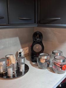 a counter top with plates and bowls of food at maison romantique avec spa privé in Montargis +8 photos