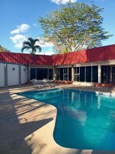 a swimming pool in front of a building at Hotel Estrella in Managua