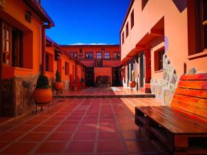 an alley with a bench and some buildings at Hostel Copacabana La Quiaca in La Quiaca