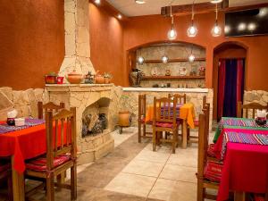 a restaurant with a stone fireplace and tables and chairs at Hostel Copacabana La Quiaca in La Quiaca