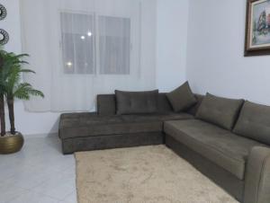 a living room with a couch and a window at Apparemment Noucer in Derroua