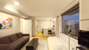 a living room with a couch and a large window at Møllergata apartment in Oslo