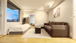 a living room with a couch and a bed at Møllergata apartment in Oslo