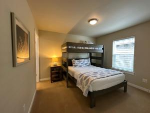 a bedroom with a bunk bed and a window at Windswept Cottage in Ocean Shores