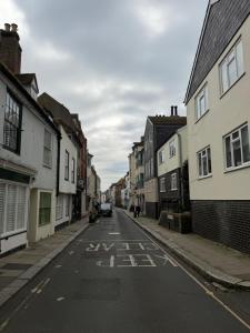 an empty street with the words stay safe on the road at Cobble retreat high street in Hastings +6 photos