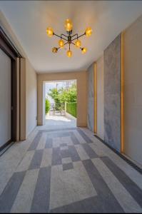 an empty hallway with a chandelier at Dedinje Luxury Apartment with Spa & Garage in Belgrade