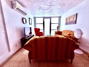 a living room with a couch and a chair at Nice and Cozy House in the Greater Ponce Area in Ponce