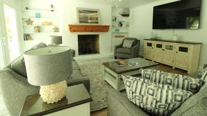 a living room with two couches and a fireplace at 8 Bedrooms With A Pool - 404 Fourth Avenue in West Cape May