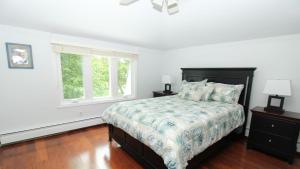 a white bedroom with a bed and two windows at 8 Bedrooms With A Pool - 404 Fourth Avenue in West Cape May +32 photos