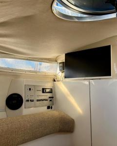 a tv in the back of an rv at HouseBoat on the river-DouroHeritage in Porto