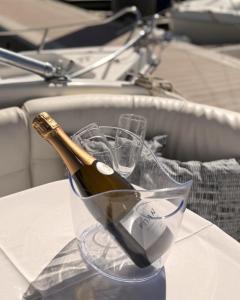 a bottle of champagne in a glass on a table at HouseBoat on the river-DouroHeritage in Porto