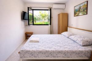 a bedroom with a bed and a window at Apartments Urban Porec in Poreč